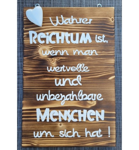 Schild geflammt  " Wahrer Reichtum..."